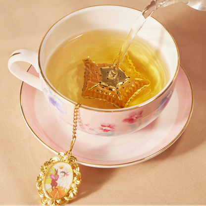 Flower Goddess's Basket star infuser brewing as water is poured into a cup