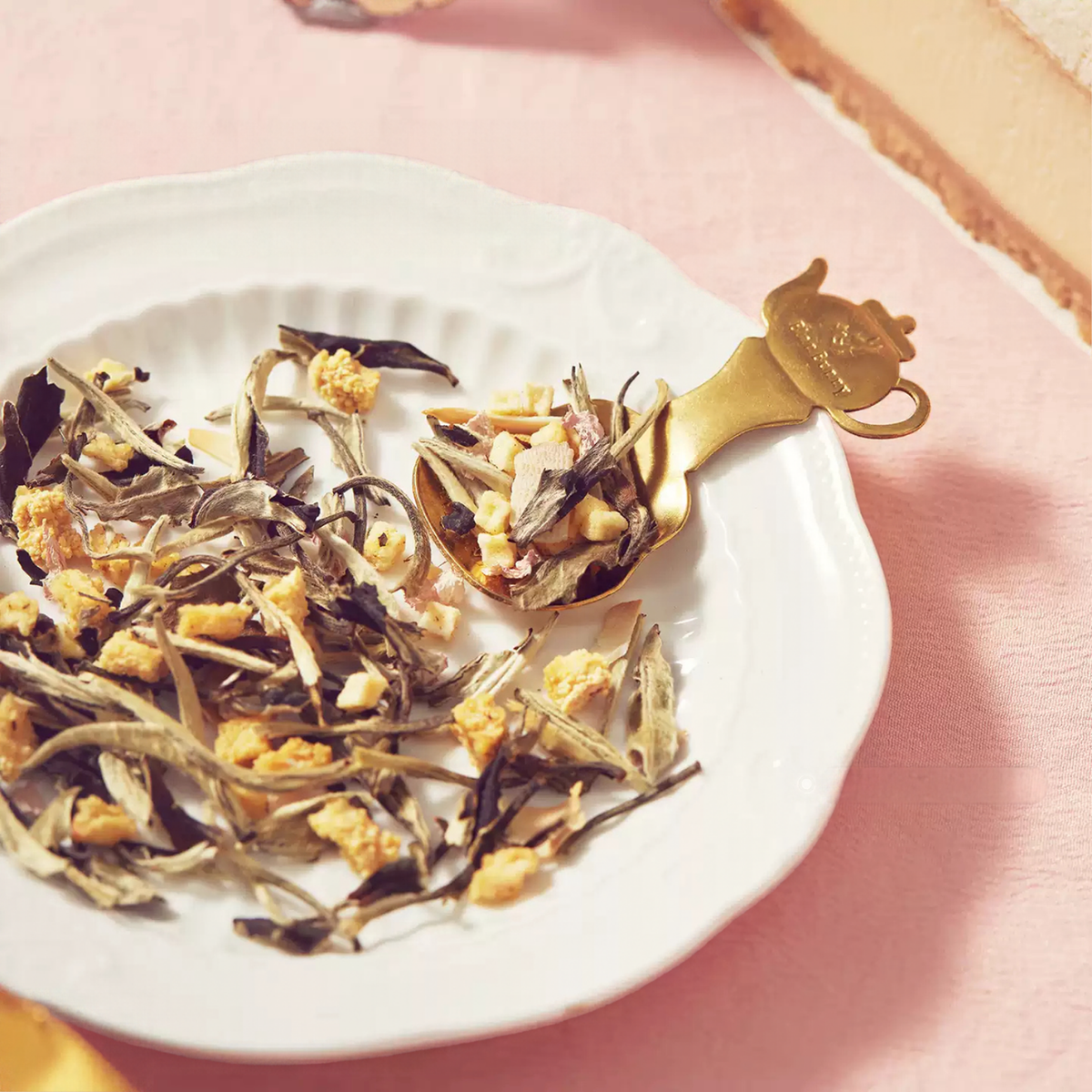 Fifth Avenue Tea Street loose tea and gold spoon on a plate