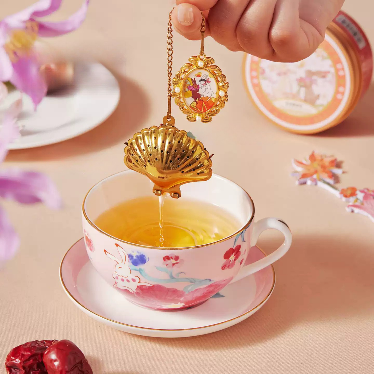 Nightingale and Rose shell-shaped tea infuser over a cup of tea