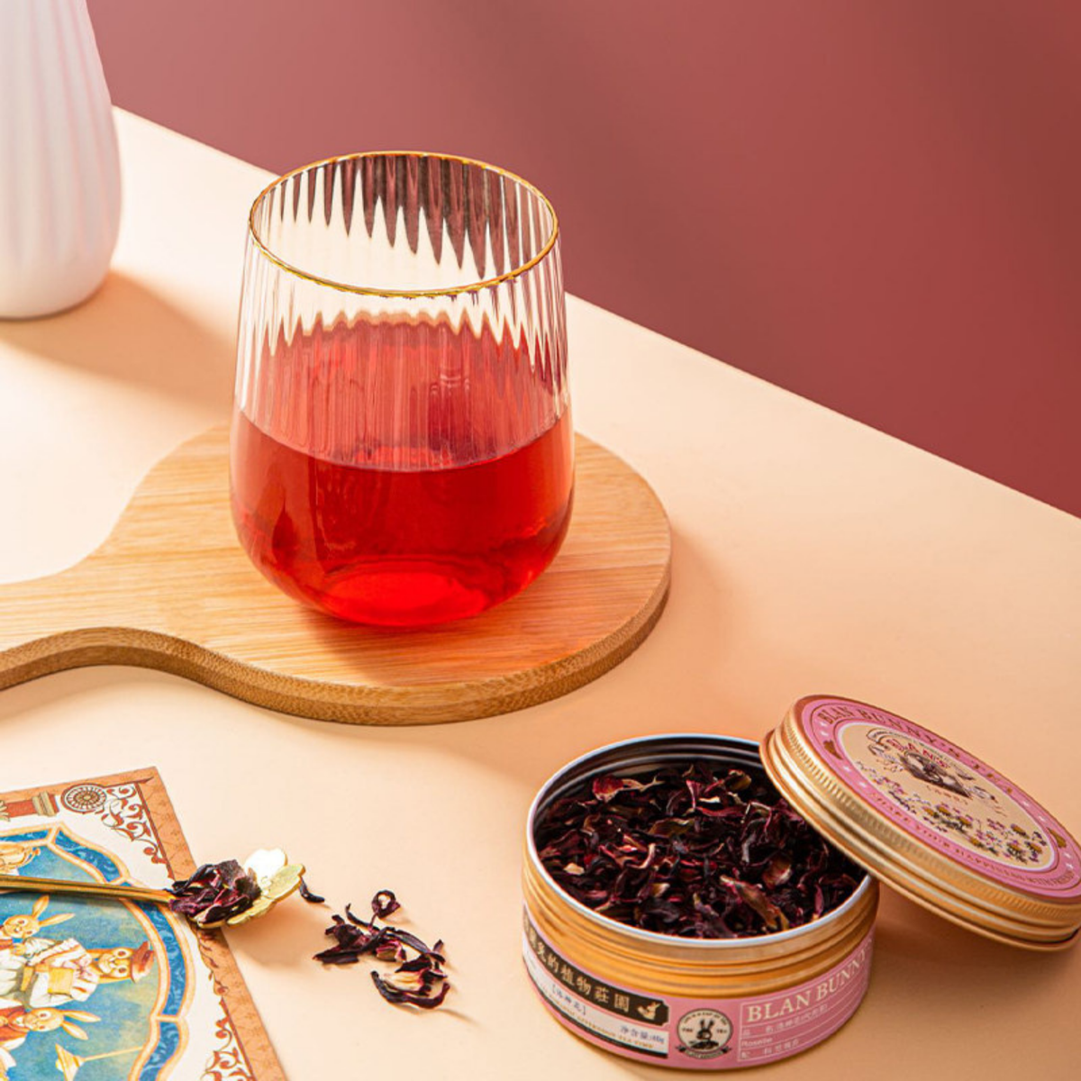 Roselle Hibiscus Herbal Tea — open tin and red hibiscus infusion